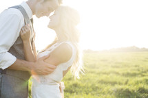 portrait of a bride and groom under intense sunlight