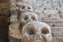 skulls carved into stone steps on Mayan ruins 