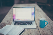open Bible, journal, computer screen, and coffee mug 
