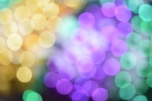 Festive Fat Tuesday bokeh lights in traditional Mardi Gras Purple, Gold, and, Green colors 