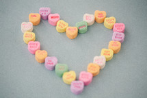 candy conversation hearts in the shape of a heart for Valentine's Day 