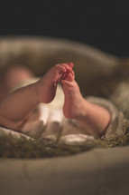 newborn feet in a manger 