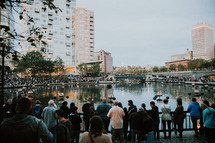 crowds gathered around a pond to view fountains 