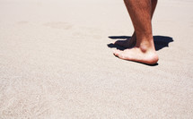 walking barefoot in the sand 