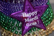 Festive Fat Tuesday beads in traditional Mardi Gras Purple, Gold, and, Green stripes 