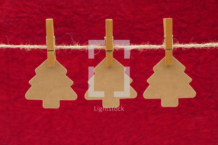  Christmas tree cut-outs hanging on a string 