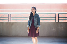 portrait of a young Asian woman standing in a parking garage 