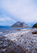rainbow near a beach shore 