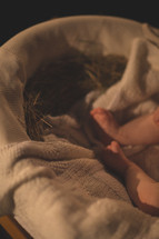 a newborns feet in a manger 