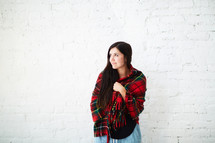a woman wrapped in a plaid shawl 