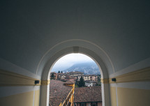 View through an archway of a mountain village.