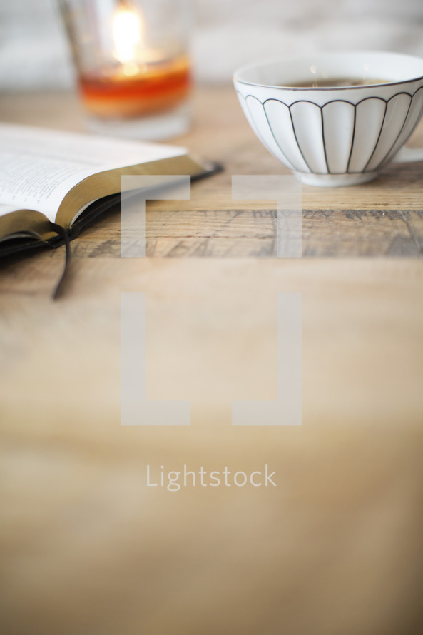 tea, Bible, and candle on a table 