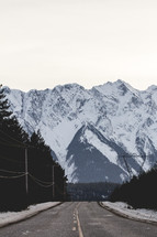 snow covered mountain peaks and power lines 