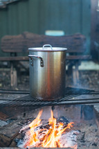 cooking a pot over a fire 