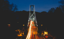 blur of headlights and taillights on a bridge 