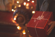 a man holding a wrapped Christmas present 