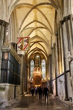 people walking in a cathedral hall 