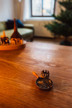 incense burner on a wood table and Christmas tree 