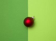 red ball ornament on green background 