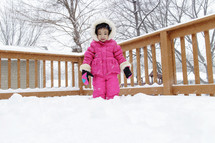 a toddler in a snowsuit 