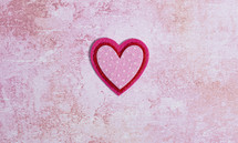 Simple Background with Felt Love Hearts on a Pink Background