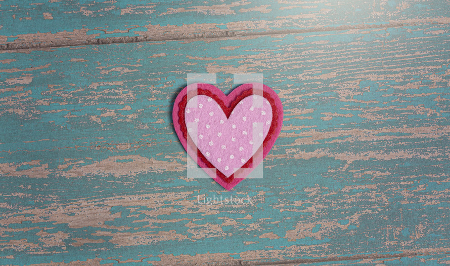 Simple Background with Felt Love Hearts on a blue wood  Background