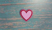Simple Background with Felt Love Hearts on a blue wood  Background