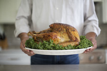 a man holding a Thanksgiving turkey 