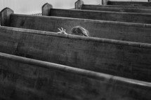 a child sitting in a church pew 