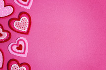 Simple Background with Felt Love Hearts on a Pink Background