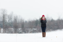 a teen girl playing in the snow 