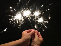 hands holding sparklers 