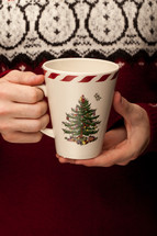 holding a Christmas mug 
