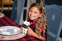 smiling little girl holding hot cocoa 