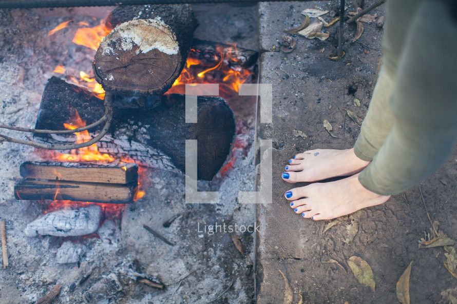 barefoot by a fire 
