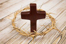 crown of thorns around a wooden cross 