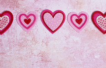 Simple Background with Felt Love Hearts on a Pink Background