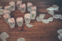 pink flowers in glasses and petals 