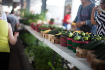 people shopping for produce at a farmers market 