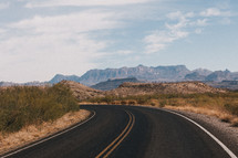 a road through desert landscape 