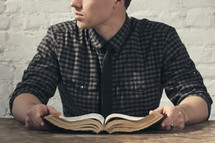 A man holding an opened Bible 