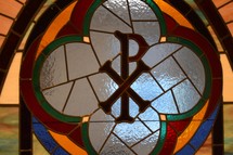 stained glass window of chi and rho ΧΡ for the Greek word ΧΡΙΣΤΟΣ Christ