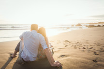 a couple sitting on a beach 
