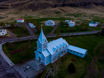 aerial view over a blue church 