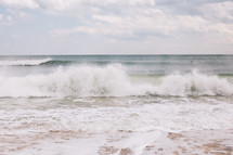 waves crashing onto a shore 