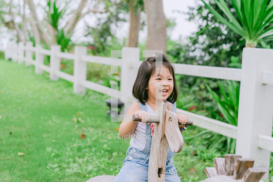 a little girl on a seesaw 