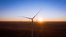 Aerial shot of wind turbines at sunrise.