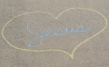 word Jesus with heart in sidewalk chalk 