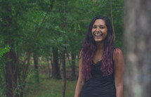 a joyful woman in a forest