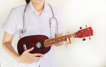a healthcare worker holding a musical instrument